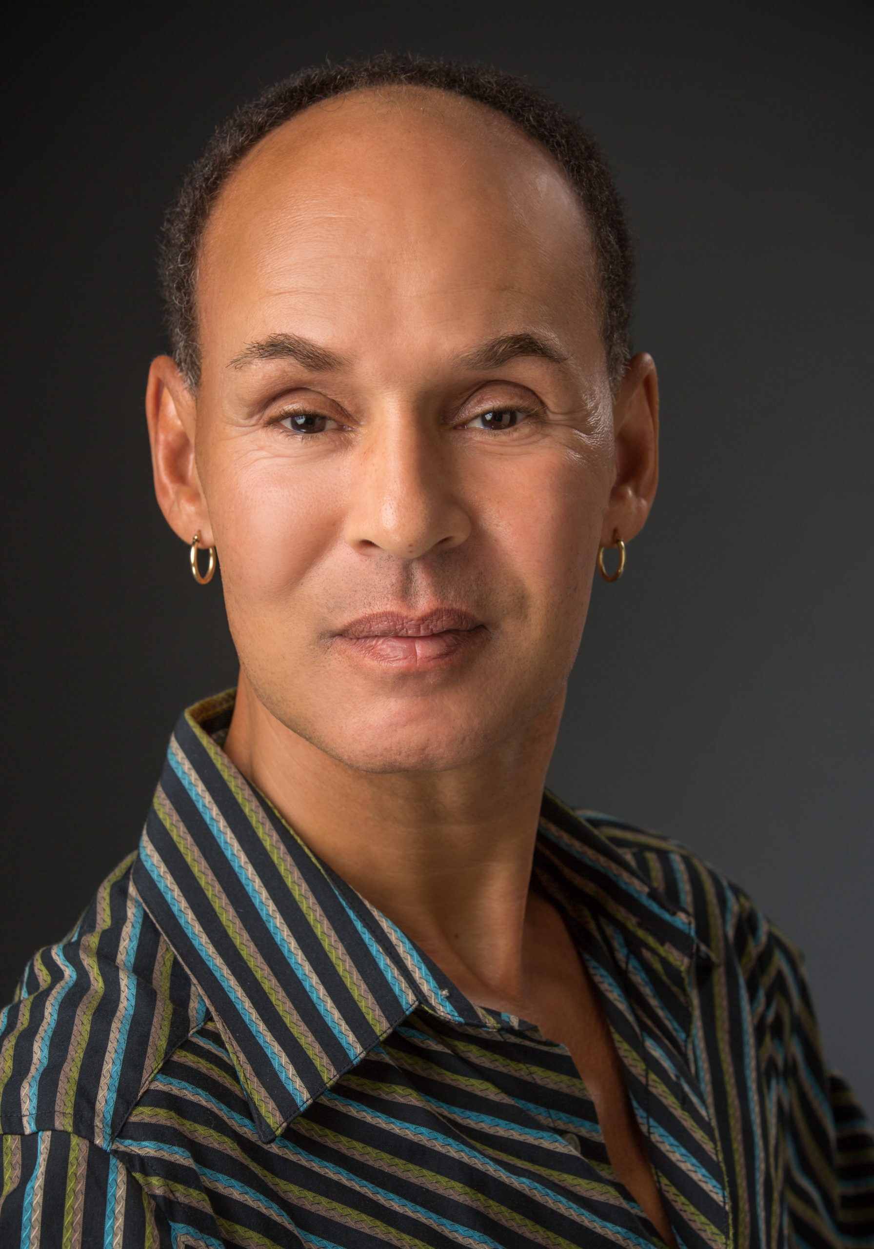 headshot, Jacob in stripped shirt with a gradiant background